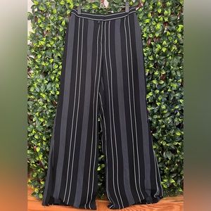 Black and white striped flare pants with a cut on the bottom. Size S